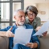 old-couple-looking-at-mortgage-note